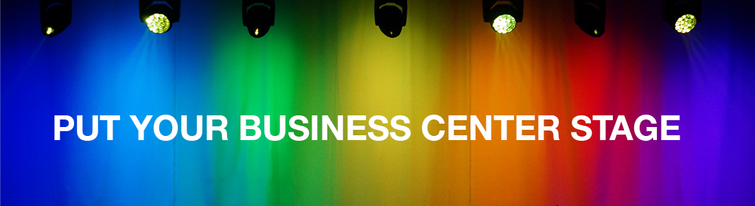 A row of stage lights shining down on a rainbow-colored backdrop with the text “Put Your Business Center Stage” in bold white letters.